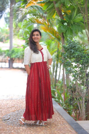 Woman in a red striped cotton maternity maxi dress with ivory yoke and nursing-friendly button design – Aayizhai Fashions.