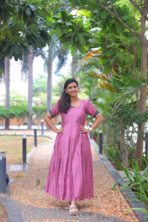 Woman in pink silk cotton maternity maxi dress with half sleeves, outdoor shoot – Aayizhai Fashions.
