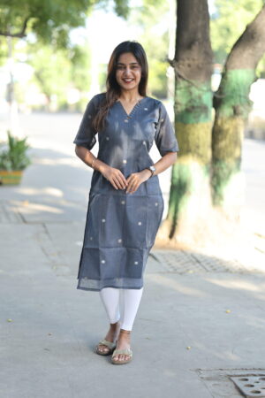 Woman wearing blue handwoven cotton kurti with woven motifs – Aayizhai Fashions.