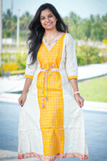 Woman wearing Yellow Malar tissue cotton kurti with dupatta, Aayizhai ethnic wear, outdoor photoshoot