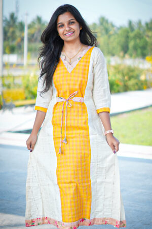 Woman wearing Yellow Malar tissue cotton kurti with dupatta, Aayizhai ethnic wear, outdoor photoshoot